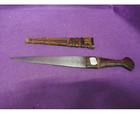 A Nigerian dagger with leather handle and decorated leather scabbard