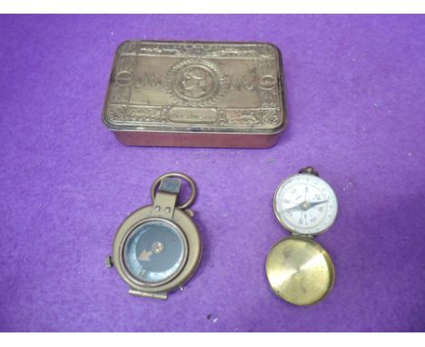 A World War I 1915 E. Koehn Geneva military marching compass, a German compass and a Queen Mary 1914 Christmas tin 