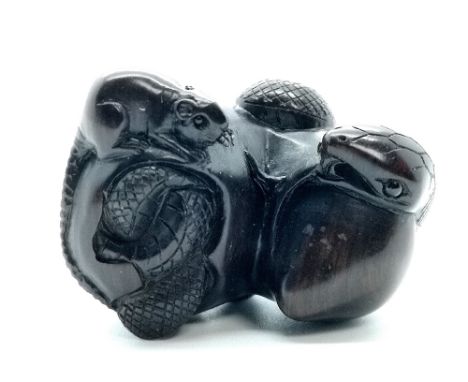 A signed carved wooden Japanese netsuke of a rat and trapped snake