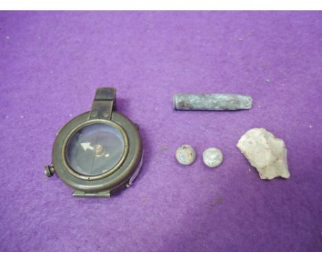 A British 1917 World War I compass, plus two shrapnel balls, German cartridge, neolithic flint, all found at Hawthorne Crater