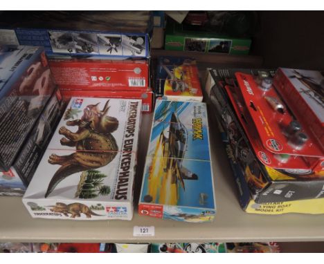 A shelf of mixed vintage plastic kits including Revell, Tamiya, Airfix etc, all boxed and most sealed