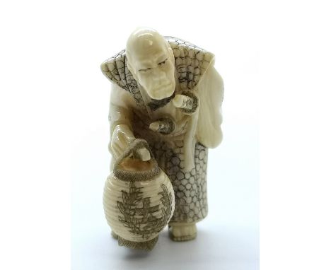 A signed carved ivory Japanese netsuke of a standing old Samurai