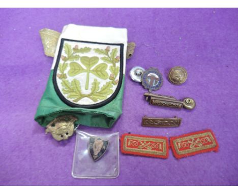 A small collection of badges and buttons including Irish Army Reserve badge 1940's