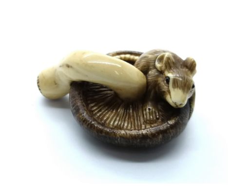 A signed carved ivory Japanese netsuke of a mouse eating a mushroom