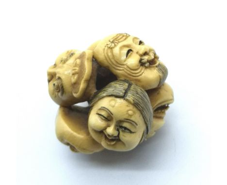 A signed carved ivory Japanese netsuke six mask study 