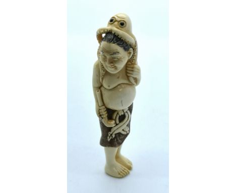 A signed carved ivory Japanese netsuke of a smiling fisherman standing with an octopus on his head and an opium pipe in his h