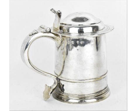 A Queen Anne Britannia silver lidded tankard, circa 1711, of plain tapered shape, the domed lid with acanthus thumbpiece, scr