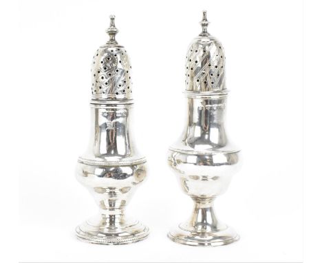 A near pair of George III silver pepper pots, London 1787 and 1789, both of traditional form, with turned finial to pierced d