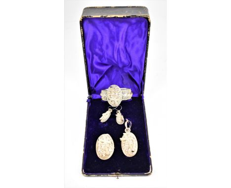 An Indian white metal filigree bridal parure set, to include a bangle, a pendant, a brooch and a pair of earrings, all intric