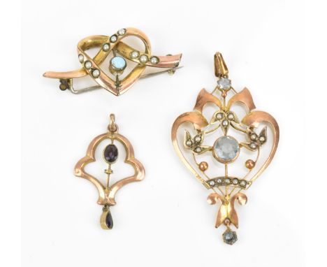 Two Edwardian pendants and a brooch, to include a larger 9ct gold pendant of pierced foliate design with seed pearls and ligh