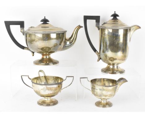 A George V silver four piece tea and coffee set by Walker &amp; Hall, Sheffield 1928, comprising a teapot, coffee pot, twin-h