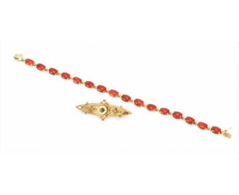 A Victorian 9ct yellow gold and ruby brooch, with rose gold design, central cut ruby in starburst setting, the back stamped 9