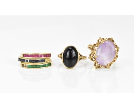 A small collection of dress rings, comprising a 9ct yellow gold and amethyst ring, with pierced mount, a 9ct yellow gold ring