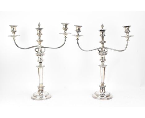 A pair of silver-plated Adam style candelabra, with twin-arms in a scroll and central light, the nozzles and drip pans with g