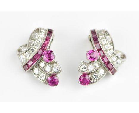 A pair of Art Deco ruby and diamond clip on earrings, with graduated trail of old European cut diamonds and a trail of channe