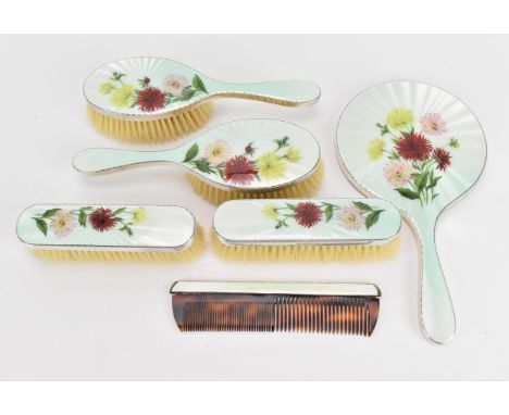 An Elizabeth II silver and enamel dressing table set retailed by Garrard &amp; Co, makers initials TP, London 1957, comprisin