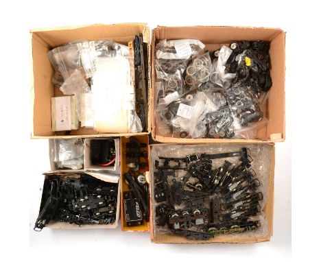 OO gauge model railway spares and locomotive parts, three trays including wheels, trucks, chassis, links, motor parts and oth