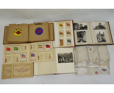 Album and contents of Kensitas cigarette silks depicting flags of the British Empire, a postcard album and contents depicting