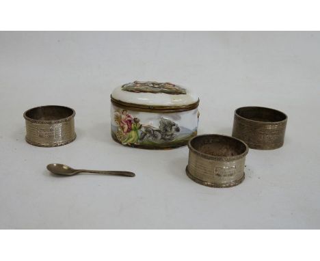 Three silver napkin rings and a porcelain snuff box of oval form, the top of the hinged cover depicting a hunting scene, the 