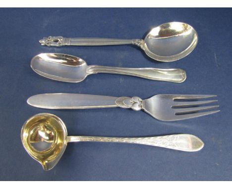 Three Danish Georg Jensen silver pieces of flatware comprising two spoons and a fork with stylised details, together with a f