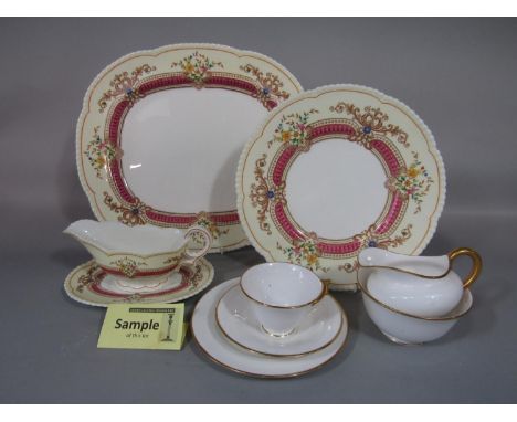 A collection of Cauldon China dinnerwares comprising a pair of oval meat plates, sauce boat and stand, a pair of tureen bases