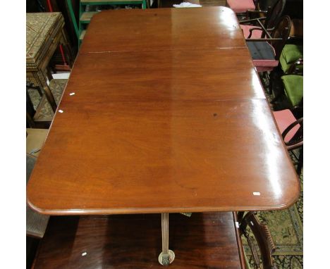 A late regency period mahogany twin pedestal extending dining table, with single additional leaf, the  pillars with turned co