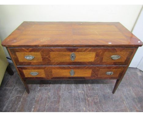 A late 18th century/early 19th century continental commode with two drawers, crossbanded borders, chequered string inlay, bra