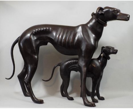 Contemporary bronze figure of a whippet in standing pose and further smaller example, 48 cm in height and smaller 