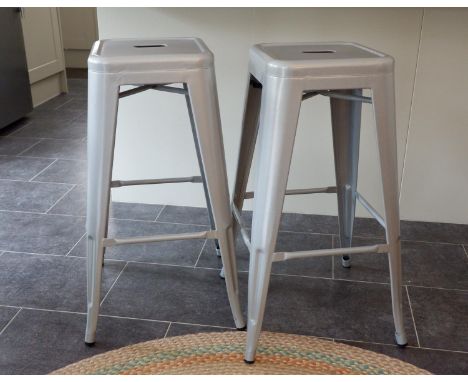 A set of four light grey painted steel stacking bar/breakfast stools with pierced square and rounded seats raised on splayed 