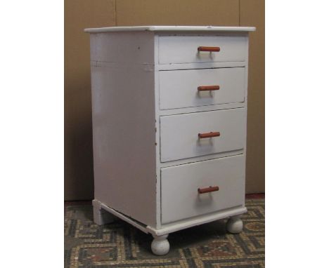 A small Victorian painted pine chest of four long graduated drawers raised on turned bun feet containing a quantity of miscel