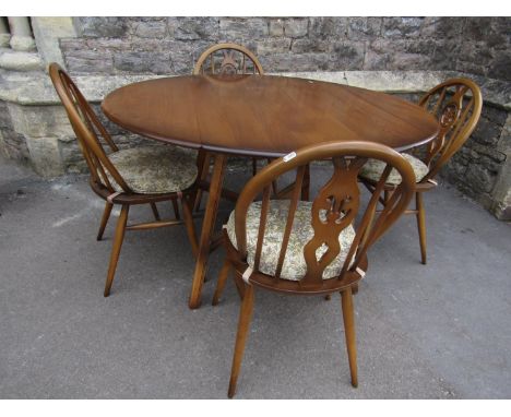 An Ercol medium elm and beechwood oval drop leaf cottage dining table raised on splayed square cut and moulded supports unite