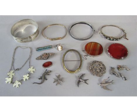 Collection of antique silver / white metal jewellery to include four bangles, two polished agate brooches, two brooches model