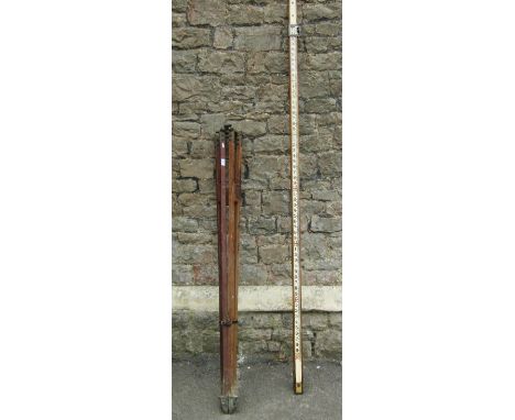 A vintage wooden surveyors level and folding stand 