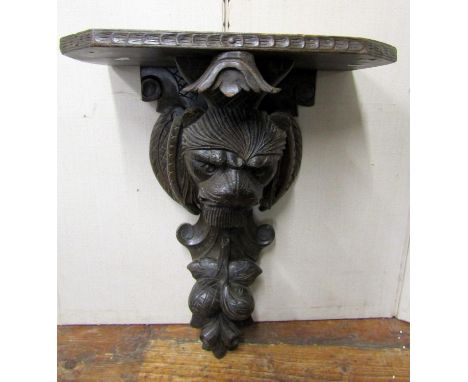 19th century carved oak bracket with lion mask and fruit detail, 60cm high 