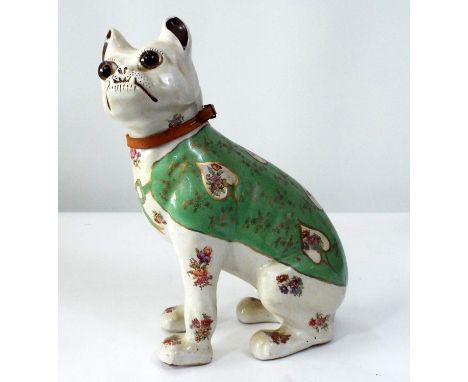 A ceramic model of a seated Pug with floral sprays, green coat and other detail, 32cm tall 