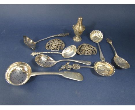 A good collection of interesting silver spoons comprising scallop shell caddy spoon, further caddy spoon embossed with a land