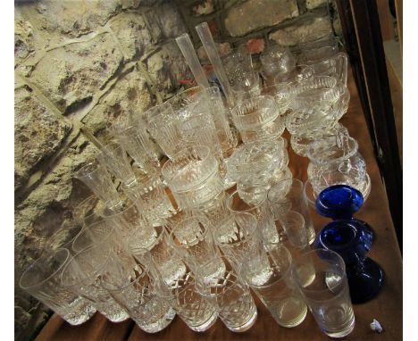 A large collection of various cut glassware including sundae glasses, tumblers, fruit bowls, jugs, etc (most of a shelf) 