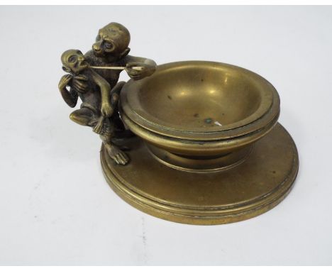 An unusual Victorian brass bowl, to one side an adult and child monkey, the larger holding a stick, 15cm diameter 