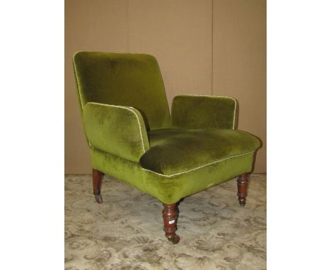 A Victorian drawing room chair with green dralon upholstered finish, unusual arm pads and raised on turned forelegs with bras