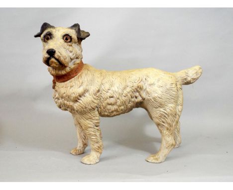 A ceramic figure of a standing terrier, the collar patriotically engraved 'I belong to the king,' 27cm high 