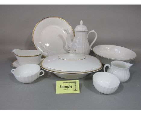 A collection of Royal Doulton Gold Concord pattern wares number H5049 comprising a pair of tureens and covers, oval meat plat