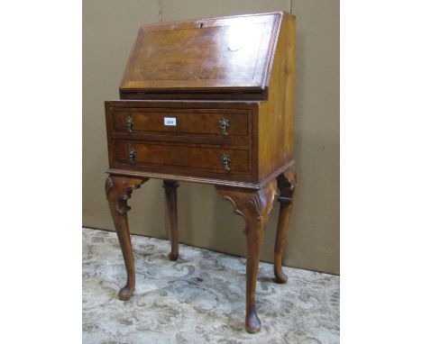 A small Georgian style walnut veneered ladies writing bureau with ebonised stringing, the fall flap enclosing a simply fitted