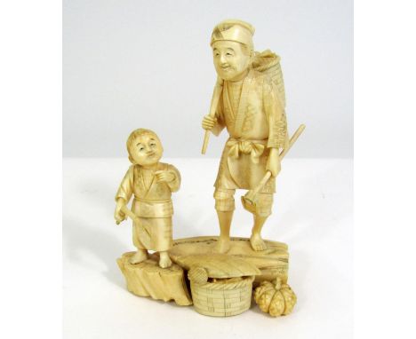 Meiji Period - Ivory Okimono of a peasant farmer and a young boy with tools, baskets and vegetables, signed, 17cm 