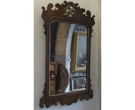 A Chippendale style wall mirror, walnut veneered with fret carved outline and hoho bird detail, 74 cm high x 44 cm wide, toge