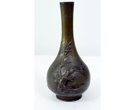 Late 19th century Japanese bronze bottle shaped vase decorated in relief, to the reverse bamboo and other plants, 25 cm in he