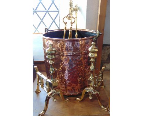 Good quality planished copper log bin with riveted bands, together with a further brass fireside set comprising two fire dogs