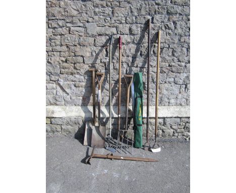A small collection of wooden long handled gardening tools, together with a vintage mountaineering pick/axe with ashwood handl