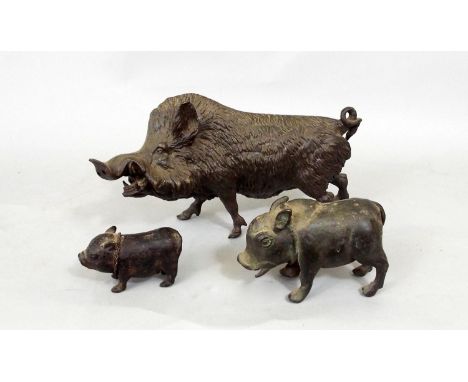 A late 19th century cast spelter model of a wild boar, with two small bronze pigs 