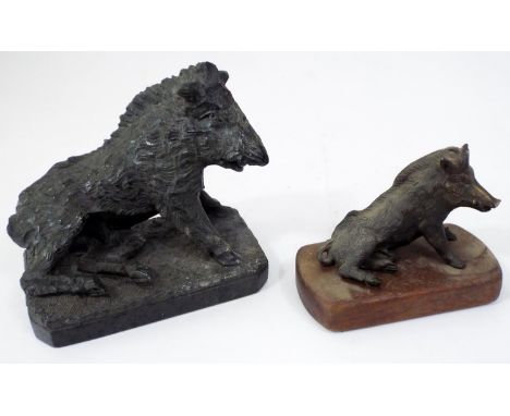 A carved serpentine figure of the Calydonian Boar and a further smaller version in bronze on a timber plinth 14 cm in length 