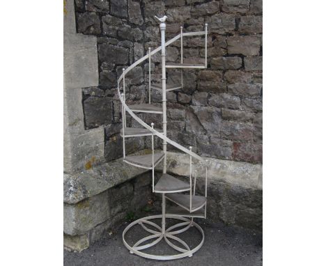 A small novel contemporary cream painted light steel framed conservatory/garden plant stand in the form of a spiral staircase